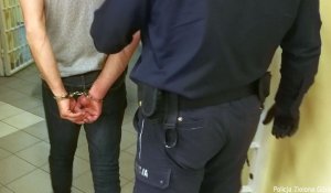 Aresztowany przeprowadzany przez policjanta.