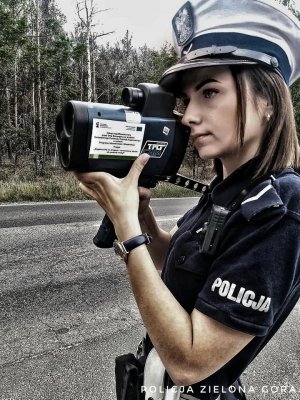 Policjantka dokonuje pomiaru prędkości pojazdu